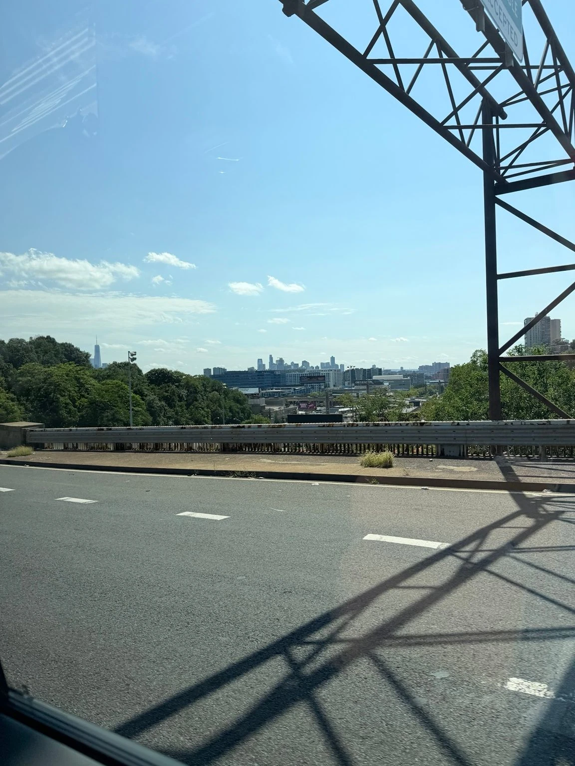 The Manhattan skyline seen from the road, under a clear sky.