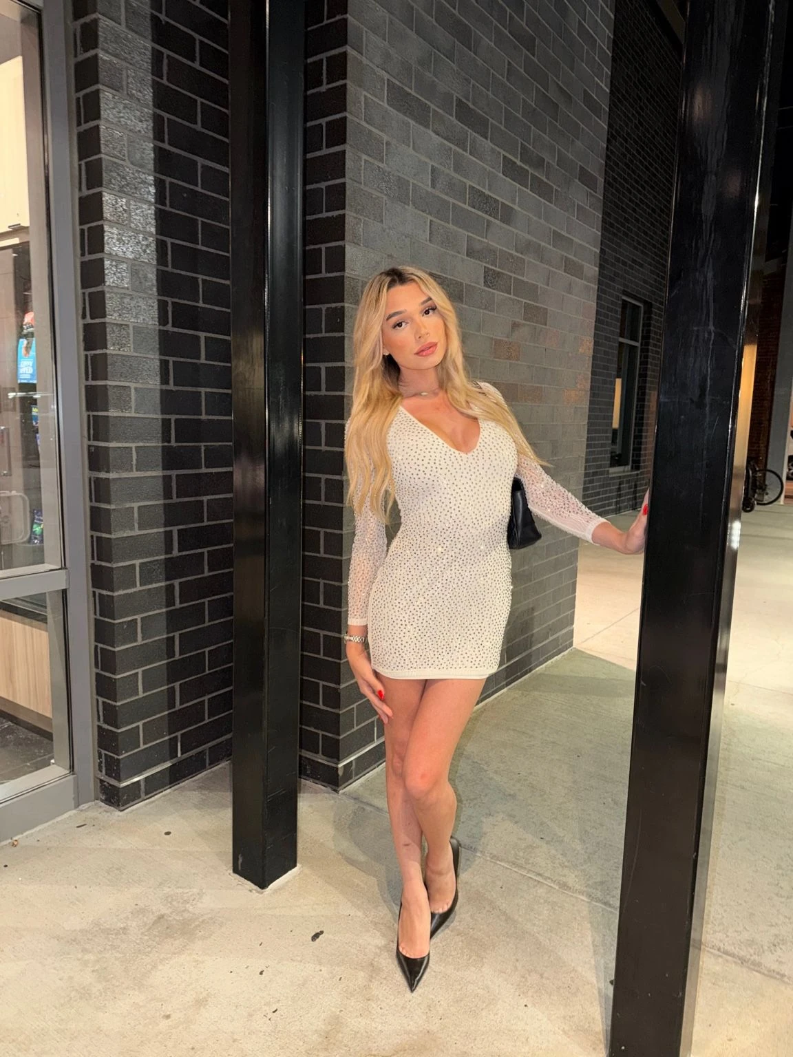 Composed and looking straight ahead in the crystal dress.